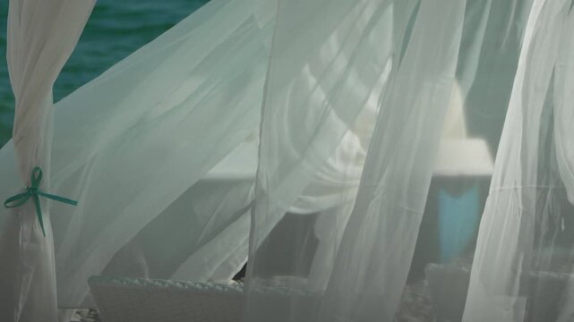 Bungalows sea. Beach Lounge bed with white silky curtains. Lounge bed with canopy at seaside. Beach Chairs and Sunshades. Summer Vacation resort concept.
