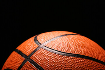 Fototapeta premium Orange basketball on black background, closeup
