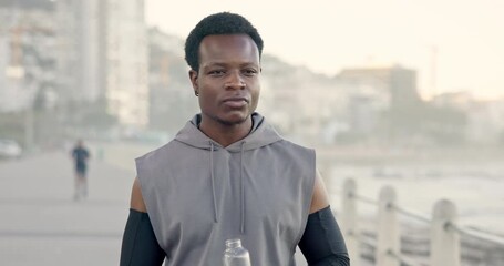 Man, fitness or drinking with water at beach for workout break, hydration or recovery. Active, male person or runner with mineral liquid, bottle or aqua beverage for sustainability on promenade - Powered by Adobe