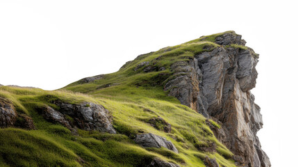 A majestic grassy cliff with rugged rock formations standing against a clear sky