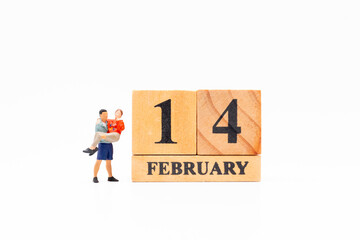 Miniature Couple Beside February 14 Valentine&rsquo;s Day Blocks