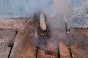 Steam coming out of pipes in an industrial plant.