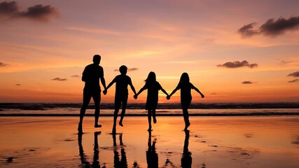 Family bond at sunset beach. Four silhouettes hold hands while walking along shore. Joyful moment captures love and togetherness. Sunset creates serene atmosphere.