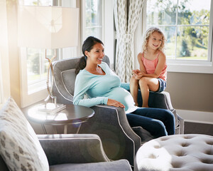 Obraz premium Maternity, family and child with pregnant mother for love, bonding and smile in home living room. Lounge, pregnancy and woman with girl, prenatal care and excited for motherhood and future sibling