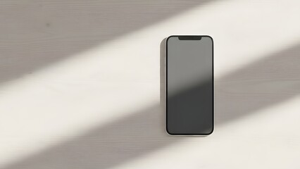 A smartphone with a gray screen is placed on a white surface, illuminated by diagonal shadows from an unseen light source, captured from a top-down viewpoint, resembling 'barunih (13).jpg'