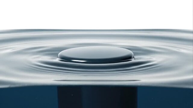 Circular object floating on water surface with ripples