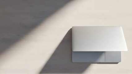A rectangular object casting a shadow on a flat surface viewed from directly above