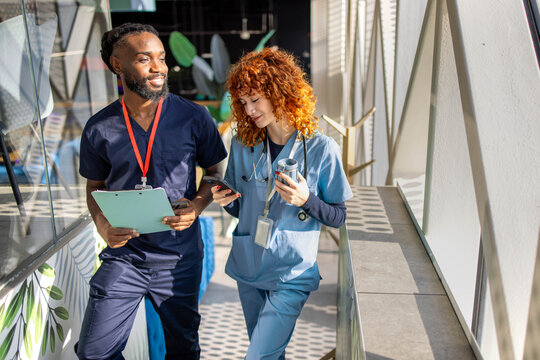Two young medical students talking during coffee break in hospital cafeteria