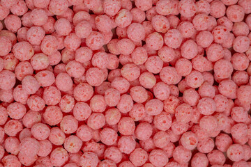 Pink dry breakfast cereal as a texture, pattern, background	