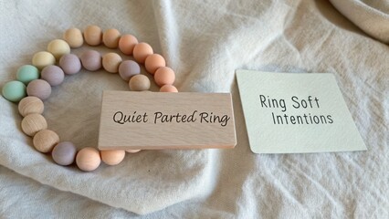 Soft Pastel Beaded Ring with Wooden Tag and Natural Fabric Background for Stylish Accessory Photography