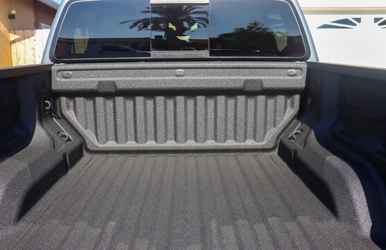 View of the back of a truck with a spray-on bed liner.