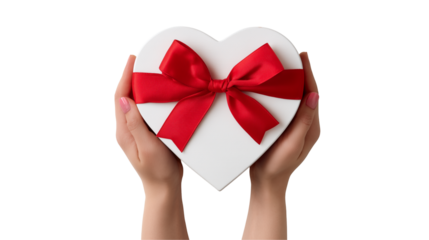 Hands holding a white heart shaped gift box with a red bow isolated on transparent background