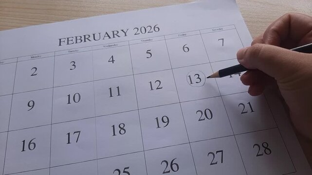 marking 13 February date on the calendar

