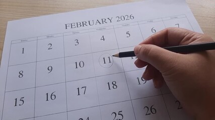 marking 11 February date on the calendar
