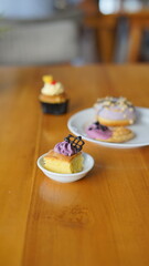 a cupcake on a white plate on a wooden table, breakfast menu in the morning, with natural lighting in the morning