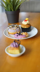 a cupcake on a white plate on a wooden table, breakfast menu in the morning, with natural lighting in the morning