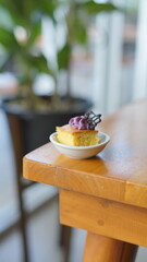 a cupcake on a white plate on a wooden table, breakfast menu in the morning, with natural lighting in the morning