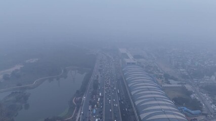 Aerial view of Sarai Kale Khan, Delhi, showing traffic and urban infrastructure under dense smog and poor air quality