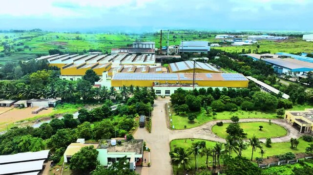 Aerial drone view of a large textile manufacturing factory in Chandrapur India showcasing extensive industrial buildings organized production units and large scale textile industry infrastructure.