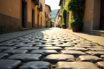Cobblestone Street Pathway in a Sunny Old Town, Leading to a Distant View