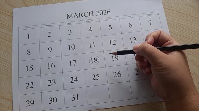 marking 18 March date on the calendar
