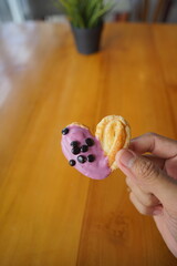 a cupcake on a white plate on a wooden table, breakfast menu in the morning, with natural lighting in the morning