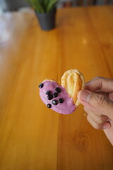 a cupcake on a white plate on a wooden table, breakfast menu in the morning, with natural lighting in the morning