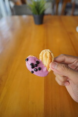 a cupcake on a white plate on a wooden table, breakfast menu in the morning, with natural lighting in the morning