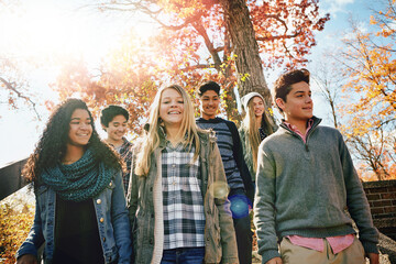 Teenager, group and walking on steps in park for autumn break, bonding together and sunshine....
