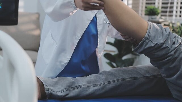 A close-up of a physical therapist or podiatrist examining and treating a patient's foot and ankle.