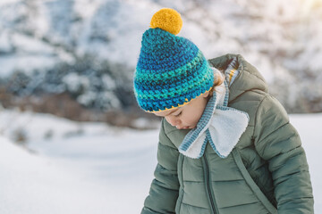 Cute Baby Boy Playing in Snow Wearing Warm Winter Clothes