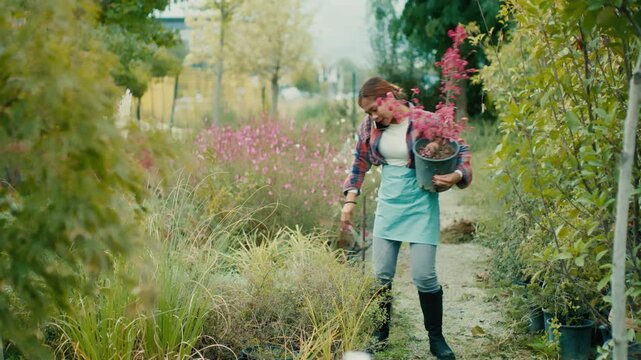 Woman Holding Potted Plant in Garden Center