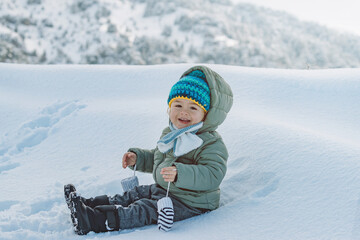 Cute Baby Boy Playing in Snow Wearing Warm Winter Clothes