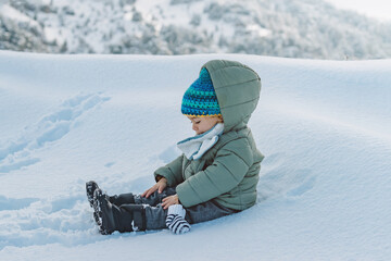 Cute Baby Boy Playing in Snow Wearing Warm Winter Clothes