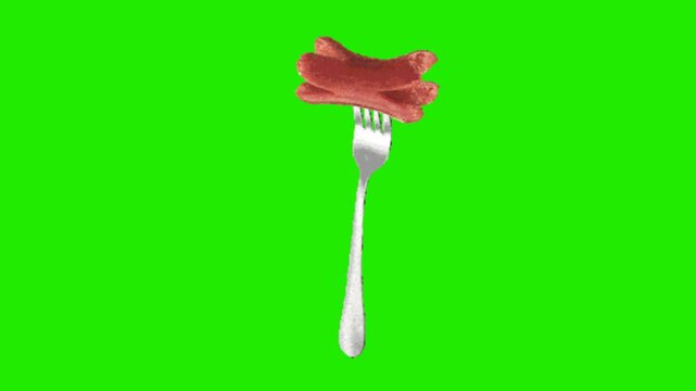 fork and sausage on green background