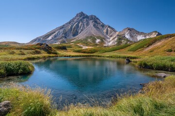 Scenic Mountain Peak Reflected in Clear Blue Lake Surrounded by Autumn Foliage Under a Bright Blue Sky in Japanese Alps