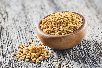 Fenugreek seeds on wooden background