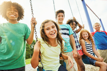 Children, portrait and swing with group of friends outdoor together for bonding or development. Break, fun and summer with happy kids at playground in park for growth, holiday or relationship