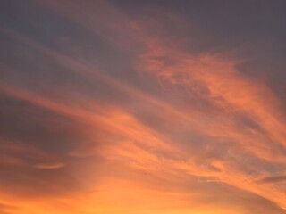 Fototapeta premium Stunning sunset sky with dramatic orange and purple clouds. Beautiful golden hour nature background.