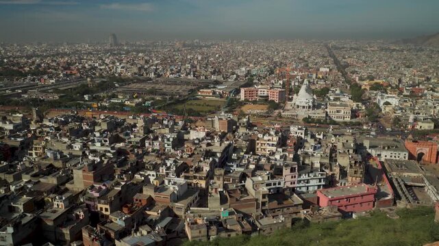 Wide angle view of Jaipur city buildings and housing from Galta Ji Mata temple hilltop horizon