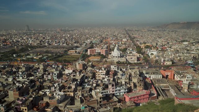 Wide angle view of Jaipur city buildings and housing from Galta Ji Mata temple hilltop horizon