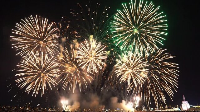 Vibrant cinematic slowmotion colorful firework rocket celebration pyrotechnic festive sparkling explosion display during a grand night holiday festival with bright trails in the sky