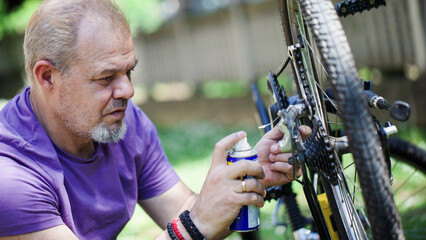Middle Aged Man Repairing Bicycle at Home