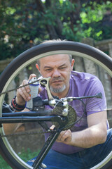 Middle Aged Man Repairing Bicycle at Home