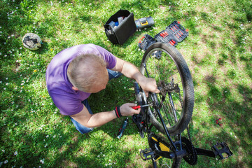 Middle Aged Man Repairing Bicycle at Home
