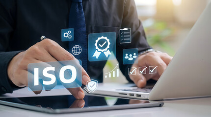 Hand of businessman using tablet with electronic pen for quality management certification and iso standard assurance concept showing checkmark and gear icons on virtual display