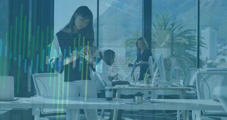 Animation of graph processing data over asian casual businesswoman using tablet at office desk - Powered by Adobe