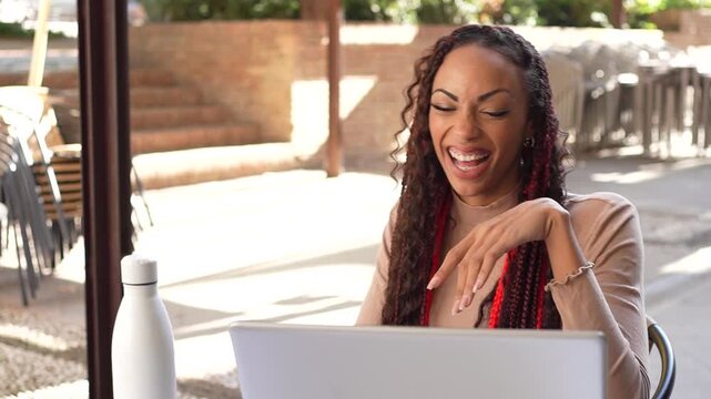 A Frustrated Woman Struggling While Working on a Laptop in an Outdoor Environment