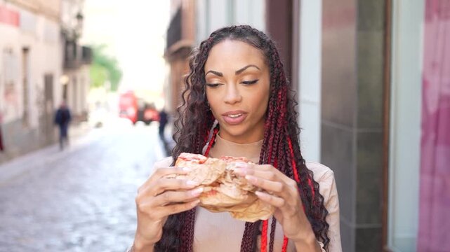 A Confident Young Woman Happily Enjoying Delicious Pizza in a Lively Urban Setting