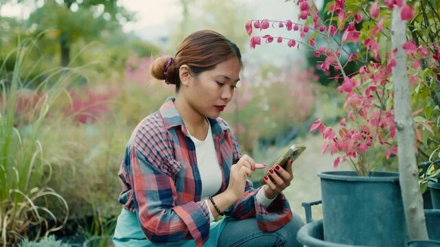 Young Woman Using Smart phone in Garden